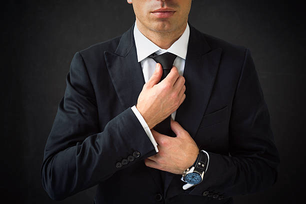 a man fixing his tie